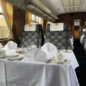 The Mayflower 4 Two seats aboard the Pullman train with a fully set dining table in front of them
