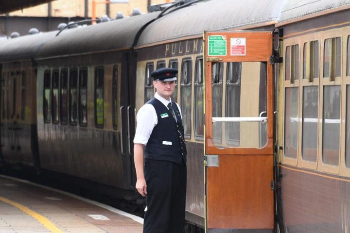 a person waiting for a train at a train station