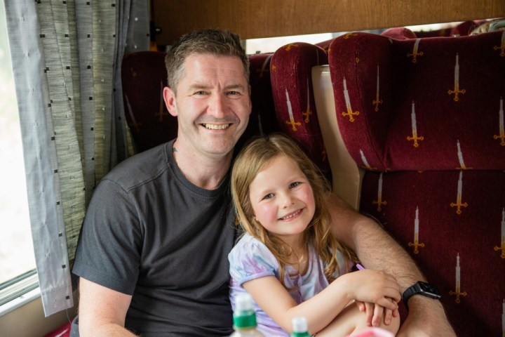 a man and a woman sitting on a chair