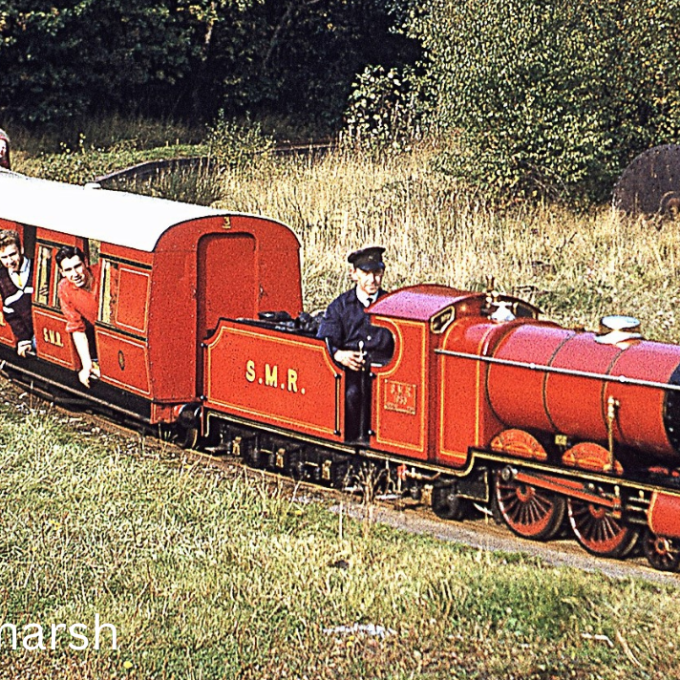 a train engine carrying carts down a track