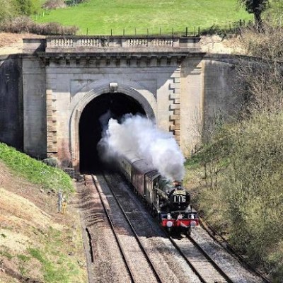 a train traveling down a dirt road
