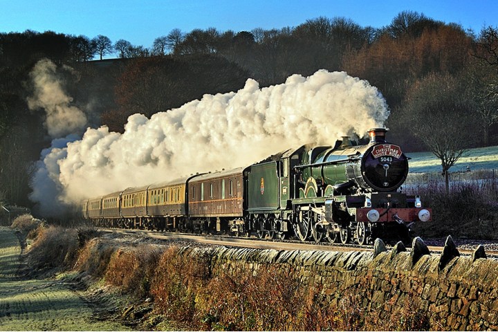 a train on a track with smoke coming out of it
