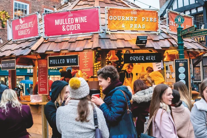a group of people standing in front of a store