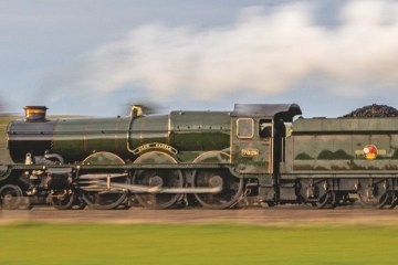 a train engine carrying carts down a track