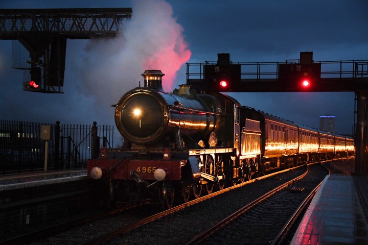 a train on a track with smoke coming out of it