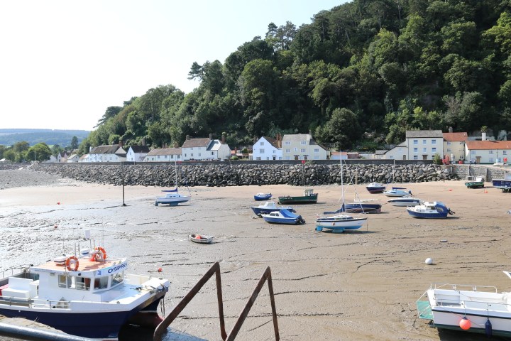 a group of people in a boat on the beach