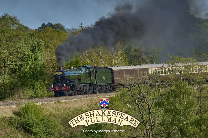 Steam locomotive 'The Shakespeare Pullman' travels through lush green countryside.