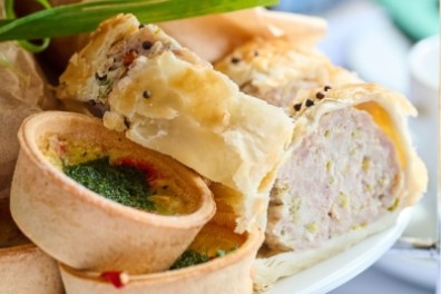 Pastry and quiche on a plate with a garnish of green onion.