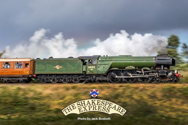 Green steam locomotive with brown carriages, labeled 'The Shakespeare Express,' moving through countryside.