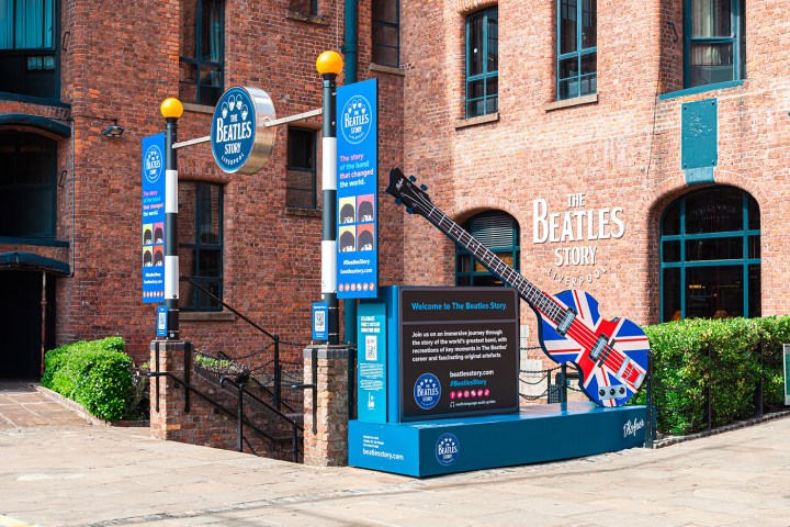 Entrance to The Beatles Story museum in Liverpool with a large guitar display.