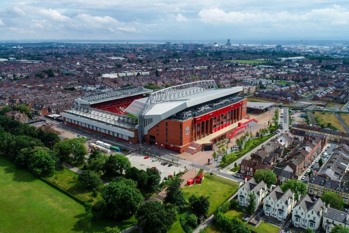 Aerial view of a large stadium surrounded by residential buildings and greenery.