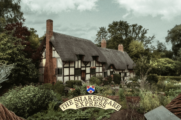 Thatched cottage with garden, framed by large woven branches.